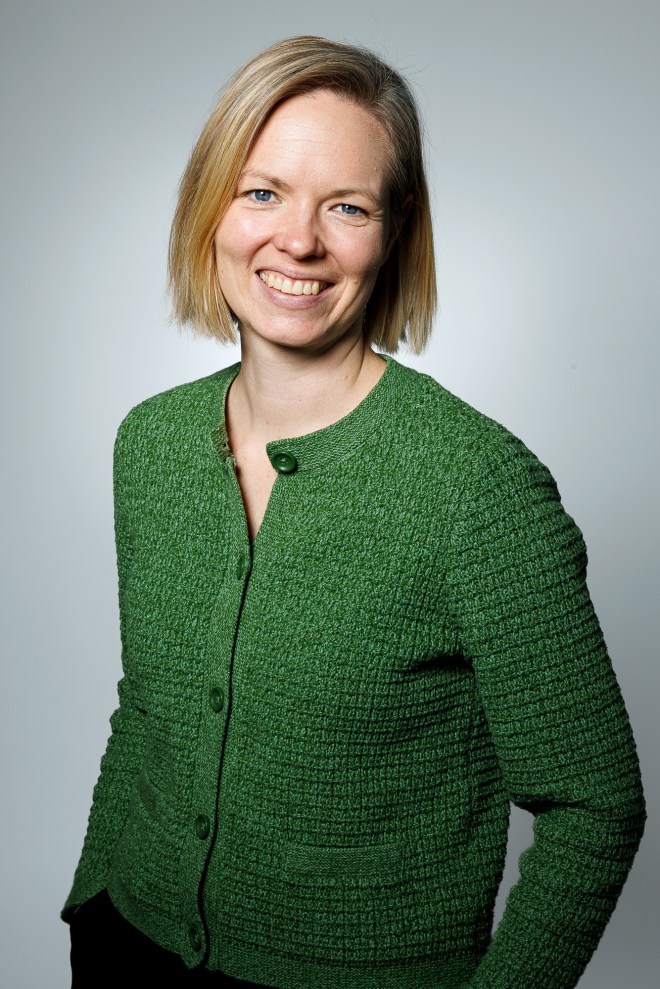 Portrait of Heini Väisänen smiling, wearing a green cardigan. Photo credit: Cyrille Krasker